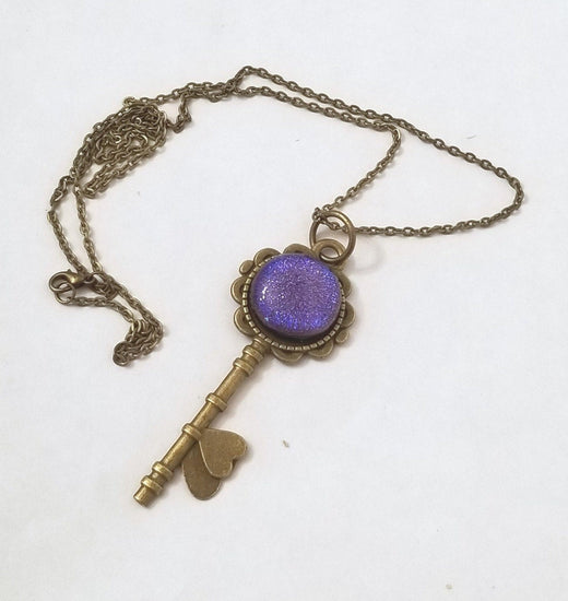 Antiqued Brass  Flowered Skeleton Key pendant necklace with Fused Glass Purple Dichroic cabochon on 24 inch brass plated chain jewelry seeds glassworks seedsglassworks