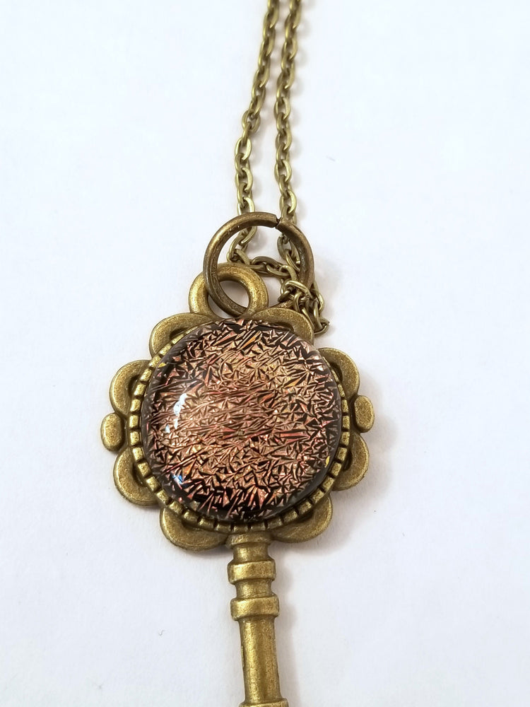 Antiqued Brass  Flowered Skeleton Key pendant necklace with Fused Glass Orange Dichroic cabochon on 24 inch brass plated chain jewelry seeds glassworks seedsglassworks