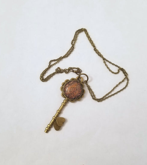 Antiqued Brass  Flowered Skeleton Key pendant necklace with Fused Glass Orange Dichroic cabochon on 24 inch brass plated chain jewelry seeds glassworks seedsglassworks