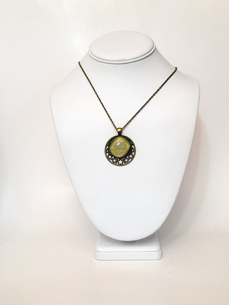 Brass Moon and Stars Pendant Necklace with Green dichroic glass cabochon on a 20 inch brass  chain. seeds glassworks seedsglassworks