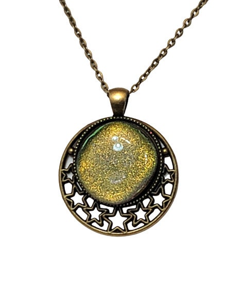 Brass Moon and Stars Pendant Necklace with Green dichroic glass cabochon on a 20 inch brass  chain. seeds glassworks seedsglassworks