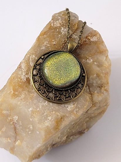 Brass Moon and Stars Pendant Necklace with Green dichroic glass cabochon on a 20 inch brass  chain. seeds glassworks seedsglassworks