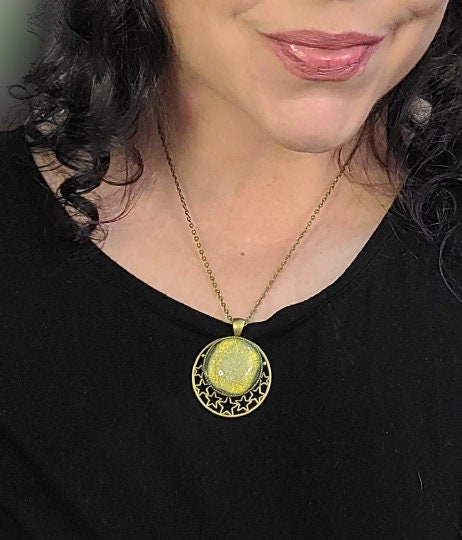 Brass Moon and Stars Pendant Necklace with Green dichroic glass cabochon on a 20 inch brass  chain. seeds glassworks seedsglassworks