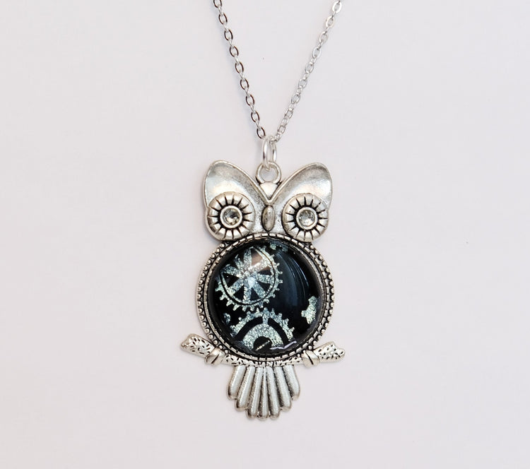 Steampunk Owl pendant necklace, silver tone  with silver gears on black dichroic fused glass center stone on an 20 inch steel chain