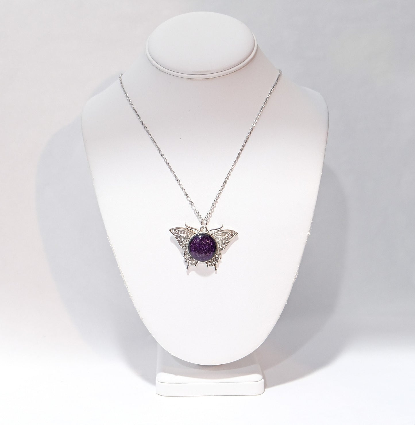 Butterfly pendant necklace, silver tone with dark purple dichroic fused glass center stone on a 20 inch steel chain
