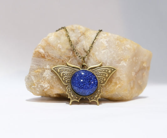 Butterfly pendant necklace, brass tone with blue dichroic fused glass center stone on a 20 inch brass chain