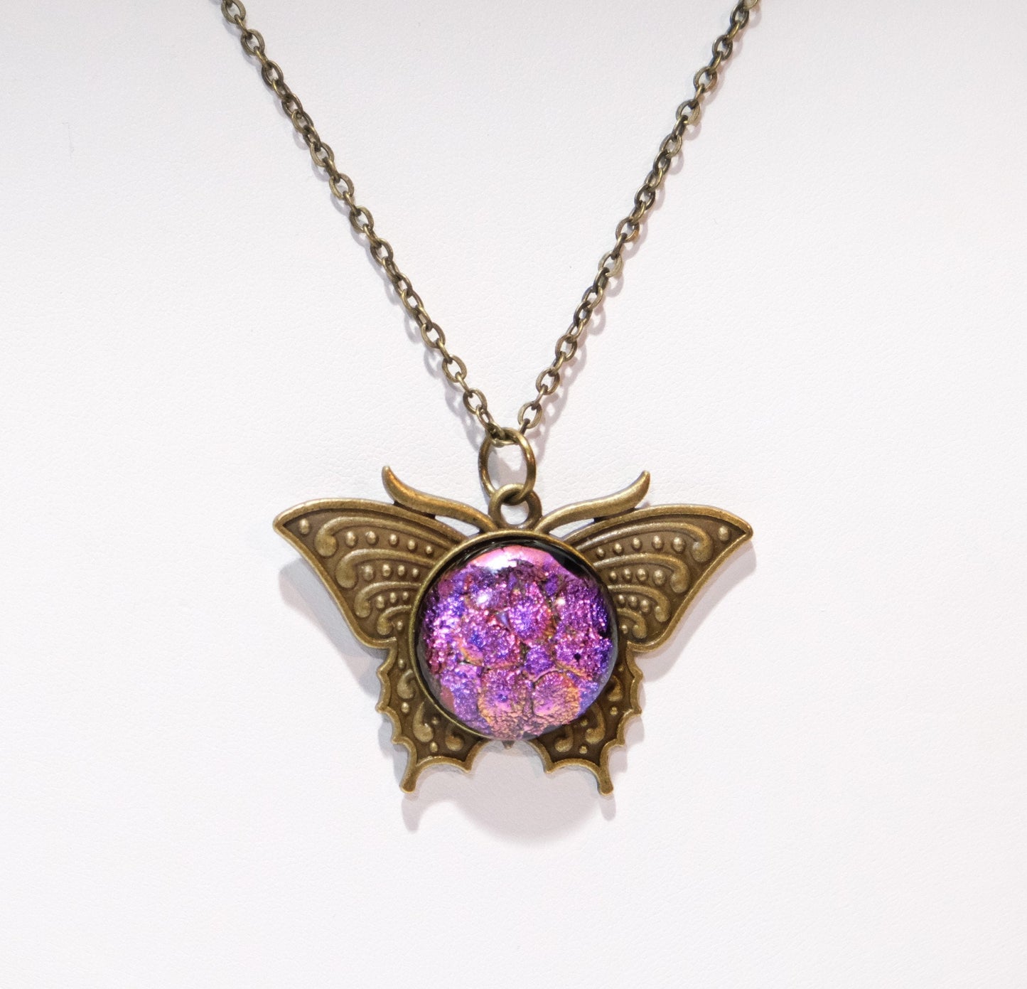 Butterfly pendant necklace, brass tone with dark purple dichroic fused glass center stone on a 20 inch brass tone chain
