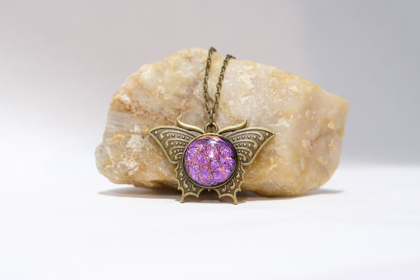 Butterfly pendant necklace, brass tone with dark purple dichroic fused glass center stone on a 20 inch brass tone chain