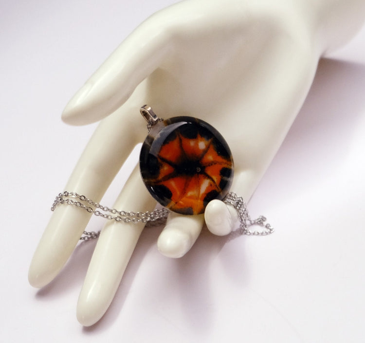 Tie Dye look Halloween fused glass pendant necklace jewelry in black, white and orange on 20 inch steel chain seeds glassworks seedsglassworks