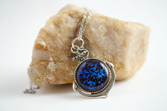 Silver Anchor pendant necklace, with blue and black sparkling dichroic fused glass center stone on a 20 inch steel chain seeds glassworks seedsglassworks