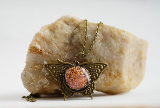 Butterfly pendant necklace, antiqued brass tone with orange dichroic fused glass center stone on a 20 inch antiqued brass chain