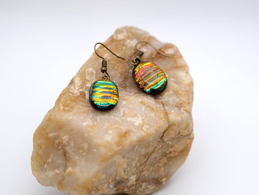 Dichroic rainbow stripes fused glass pierced dangling earrings on antiqued brass tone french wires. Approx 1.5 inches total length seeds glassworks seedsglassworks