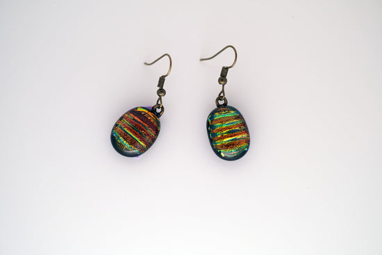 Dichroic rainbow stripes fused glass pierced dangling earrings on antiqued brass tone french wires. Approx 1.5 inches total length seeds glassworks seedsglassworks