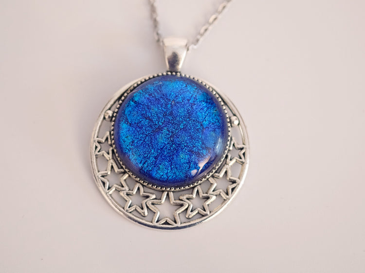 Silver tone Moon and Stars Celestial Pendant Necklace with Blue dichroic glass cabochon on a 20 inch steel metal chain.