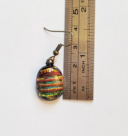 Dichroic rainbow stripes fused glass pierced dangling earrings on antiqued brass tone french wires. Approx 1.5 inches total length seeds glassworks seedsglassworks