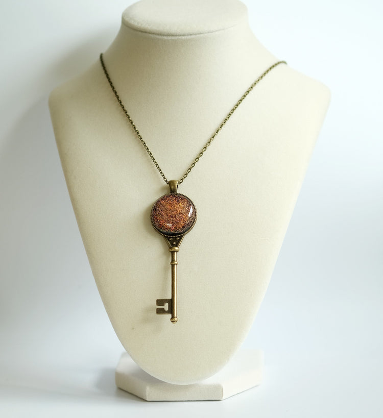 Antiqued Brass  Skeleton Key pendant necklace with Fused Glass Orange Dichroic cabochon on 24 inch brass plated chain jewelry