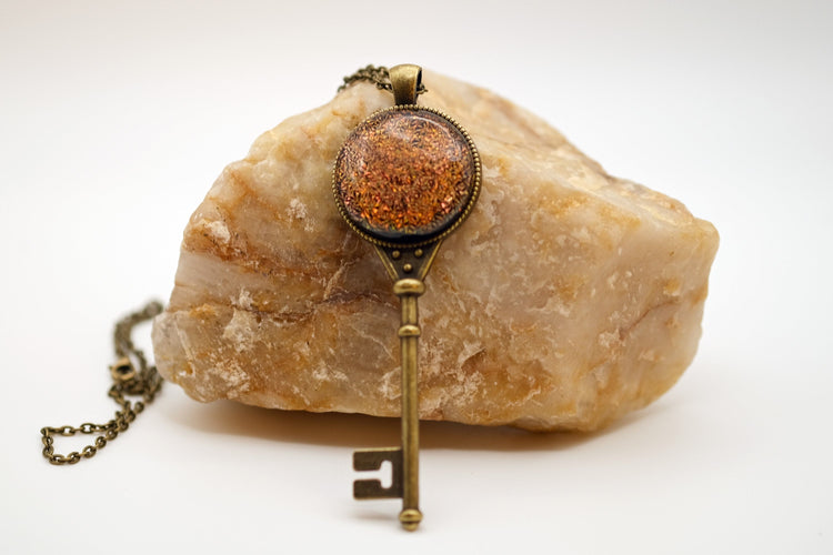 Antiqued Brass  Skeleton Key pendant necklace with Fused Glass Orange Dichroic cabochon on 24 inch brass plated chain jewelry