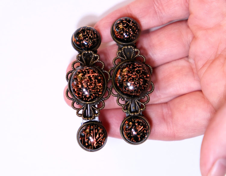 Barrette pair, bronze flowers with dark orange dichroic fused glass cabochons, french clip, 2 1/4 inches seeds glassworks seedsglassworks