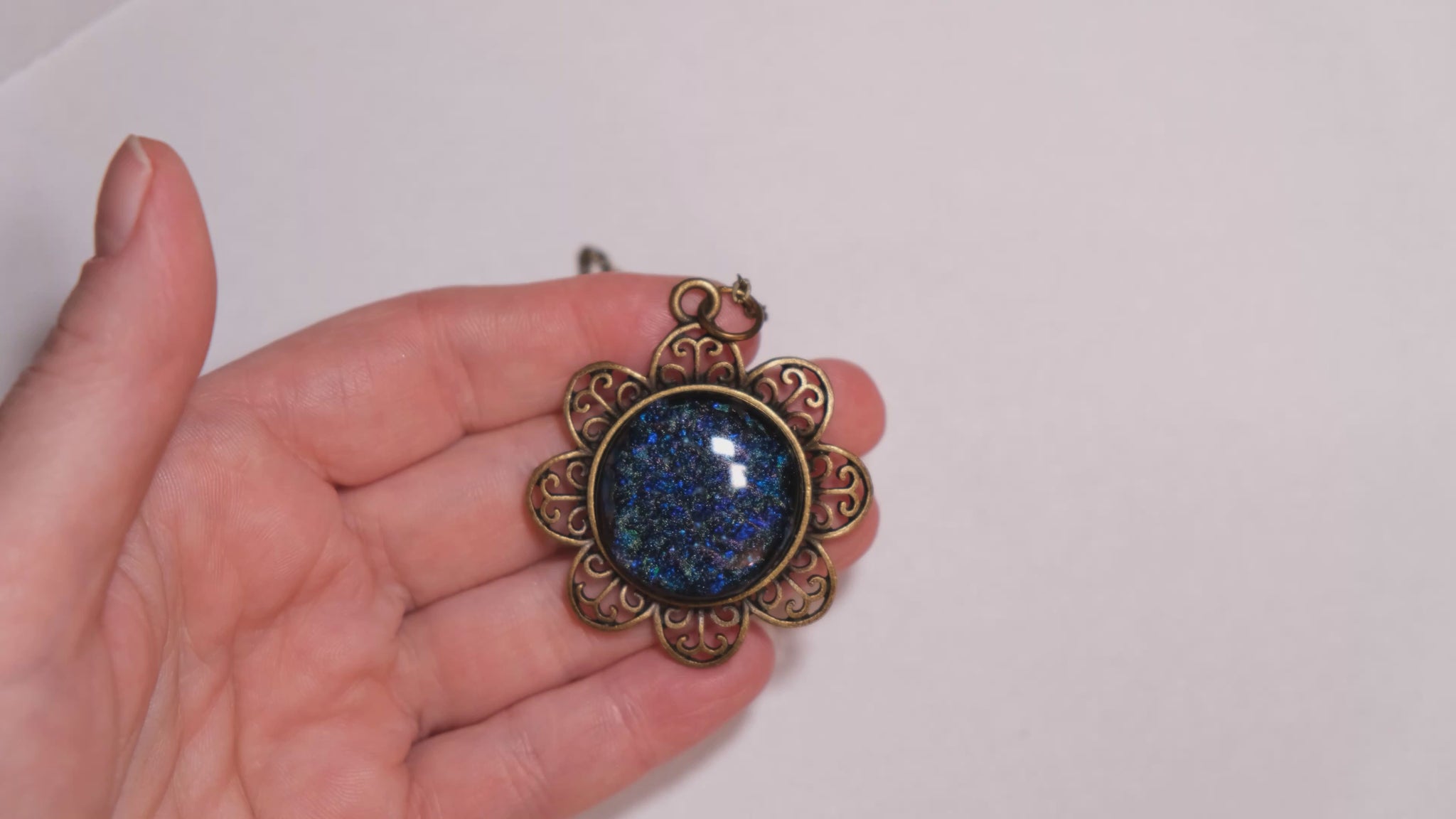 Antiqued Brass Flowered pendant necklace with Fused Glass multicolor/blue Dichroic cabochon on 24 inch antiqued brass chain jewelry. seeds glassworks seedsglassworks