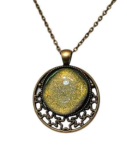 Antiqued brass Stars Pendant with Green dichroic glass cabochon on a 20 inch brass chain seeds glassworks. fused glass seedsglassworks